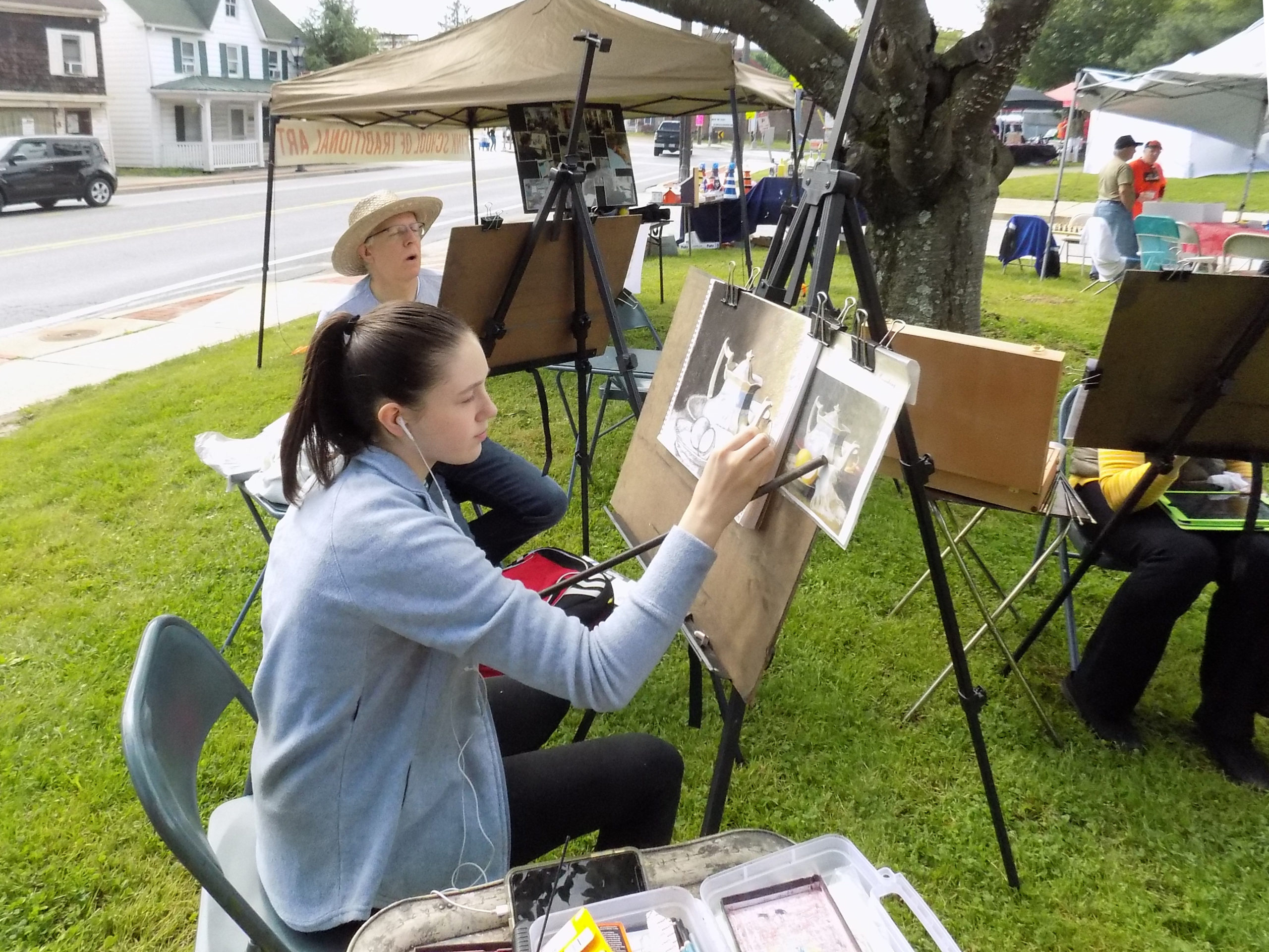 A woman painting at an easel